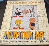 Cover of Warner Bros Animation Art book featuring Daffy Duck, Bugs Bunny, Tweety, and Porky Pig with sketches in background.