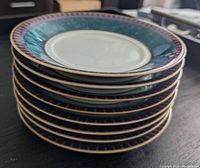 Stack of 6 dinner plates with blue-green and decorative geometric trim on edges, showing detailing of the pattern and condition.