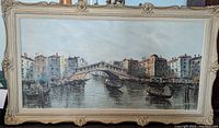 Frontal image of the framed oil painting showing canal, gondolas, and arched stone bridge.