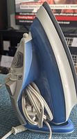 Side view of the T-Fal Ultra Glide Diffusion iron showing the water reservoir and electrical cord wrapped around the base.