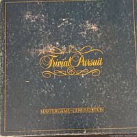 Cover of Trivial Pursuit Master Game Genius Edition with gold text on black background.