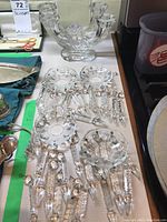 Multiple views of the flat glass candle holder showing the circular rests and spikes designed to secure candles