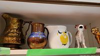 All five pitchers displayed on shelf