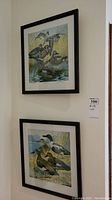 Two framed duck prints hung on a corner wall, showing detailed illustrations of ducks with natural backgrounds.