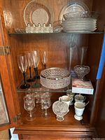 Close-up of champagne flutes, crystal bowl with silver rim, and crystal candy dish