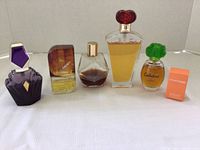 Photo showing six perfumes: five pre-owned bottles and one brand new Clinique Happy in box