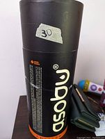 Black cylindrical packaging of the Asobu cold brew coffee maker with logo and text.