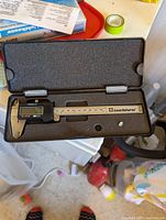 Digital slide caliper in protective foam case with display and stainless steel measuring jaws, labeled Leuchtturm.