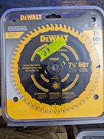 Front view of unopened DEWALT 7 1/4 inch circular saw blade in sealed yellow packaging showing blade and product details.