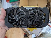 Front view of the Gigabyte GTX 1660 graphics card showing the dual fan cooling system and black plastic shroud with Gigabyte logo on the fans.