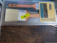 Two Blue Hawk paint brushes, 2-inch and 3-inch, in original sealed packaging with orange wooden handles and white synthetic bristles.