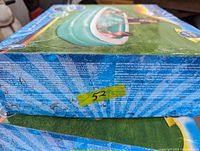 Box showing Intex brand inflatable pool with blue camouflage design unopened in packaging.