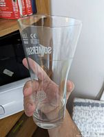 Close-up of used Sommersby branded glass showing clear glass with logo and measurements.