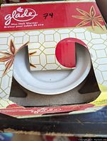 View of the Glade wax melt warmer in partially open retail box with star anise graphics and Glade branding.
