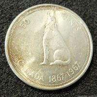 Reverse side of the coin depicting a howling wolf and inscriptions marking the centennial years and denomination.