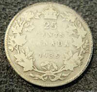 Reverse side of 1935 Canadian 25 cents silver coin showing denomination, country, year, and maple leaf wreath with crown.