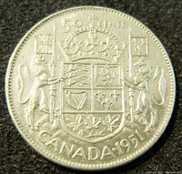 Reverse of the 1951 Canada 50 cents coin showing the Canadian coat of arms and denomination details.