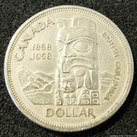 Obverse side of 1958 Canadian silver dollar coin showing British Columbia centennial totem pole design with dates 1858-1958 and inscription CANADA BRITISH COLUMBIA DOLLAR.