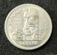 Obverse of 1958 Canadian silver dollar featuring British Columbia commemorative design with totem pole and mountains.