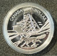 Close-up of the reverse of the coin showing a fox and a mining tower, dated 1903-2003 with text "Canada Dollar".