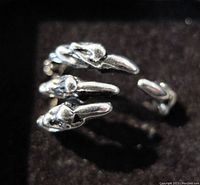 Close-up view of the claw fashion ring showing the detailed claws and open cuff design.