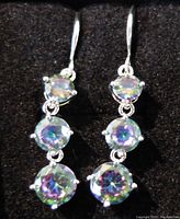 Front view of the earrings showing the prong set iridescent round stones sparkling in silver-tone metal
