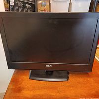 Front view of 23 inch RCA television showing flat screen and base stand with RCA logo on bezel.