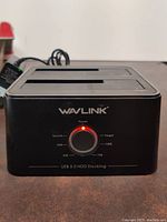 Front view of WAVLINK USB 3.0 HDD Docking Station showing dual drive slots and LED power/clone progress indicator.