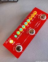 Top view of red metal Malody Cube Baby electric guitar effects pedal showing illuminated control knobs and chrome footswitch A, B, C.