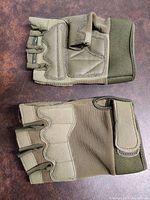 Top and palm view of tactical military gloves showing padded areas and fingerless design.
