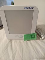 Front view of Verilux Happy Light therapy lamp showing the light panel, brand name, and attached power cord.