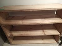 Front view of solid wood pine shelf showing three shelving tiers and natural wood grain.