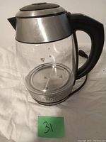 Salton cordless electric kettle showing side view with visible water level markings and black handle.