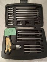 Top open view of the tool set showing multiple screwdriver bits and the bit driver organized in molded compartments inside the carrying case.