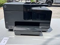 Front view of HP Officejet Pro 8610 printer showing the paper output tray and front control panel.