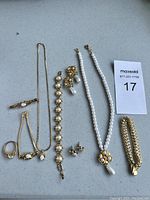 Top-down view of jewelry set laid out on a grey surface.