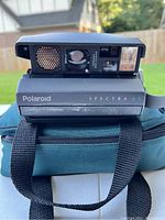 Front view of Polaroid Spectra AF camera showing lens, flash, and branding on camera body