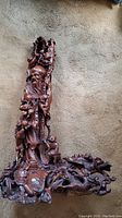 Front view of entire carving showing bearded figure and base details