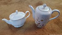 Rosenthal coffee pot and Mikasa tea pot photographed on carpet background