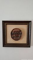 Photo of the entire framed wall art displaying the carved bog oak piece centered in the frame.