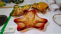 Top view of all three hand blown glass dishes showing colors, shapes and arrangement