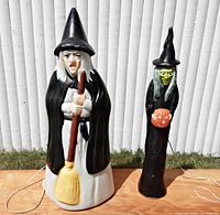 Front view of both witches side by side on plywood surface
