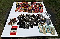 Wide view of entire lot on white background including boxed and loose tubes, electronic components, and reference book.