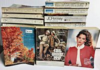 Front view of stacked catalogs showing a variety of covers including Sears Fall/Winter and JC Penney Spring/Summer issues
