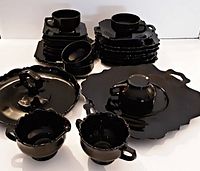 Front view showing most pieces including cups, saucers, plates, sugar bowl, creamer, and handled cake plate.