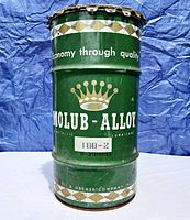 Front view of the green Vintage MOLUB-ALLOY drum can with crown logo and slogan "Economy through quality," showing scuffs and wear.