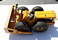 Top and side view showing overall condition and missing stack pipe of yellow toy bulldozer.