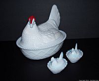 Photo showing the large white milk glass hen dish with red comb and two smaller matching white hens on nests.