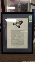 Full view of the framed document with visible price sticker, showing the entire frame, matting, and artwork inside.