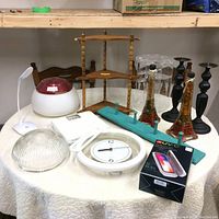 Photo showing all items including vaporizer, clock, candle holders, decorative Eiffel Tower bottles, wooden shelf, and sanitizer box